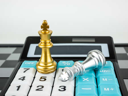 Financial games concept, Game of chess with calculator, selective focus.