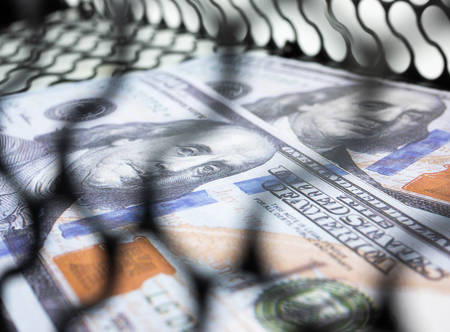 Dollars money in a mouse trap on white backgroundの写真素材