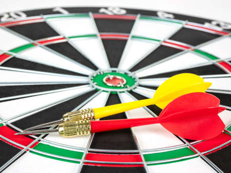 Red and yellow Dart arrows and dartboard.