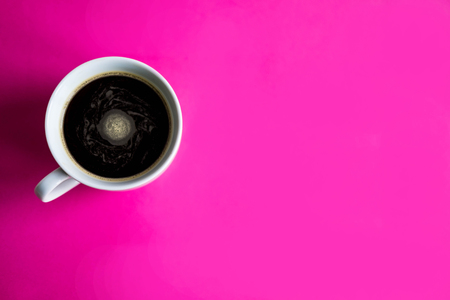 Cup with coffee on a pink background. Concept with coffee. Background with coffeeの写真素材