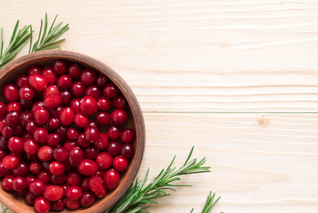 Cranberries on wooden background. Background with cranberries. Useful berriesの写真素材