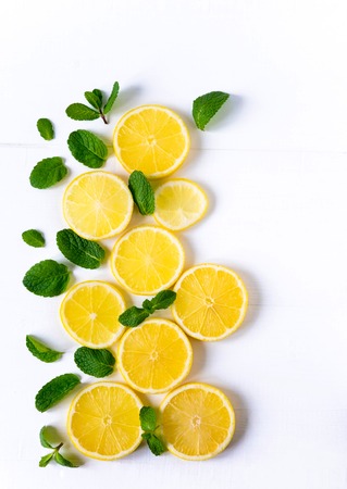 White background with lemon, orange slices and mint. Concept with fresh fruit. Lemon, Orange, Mint.の写真素材