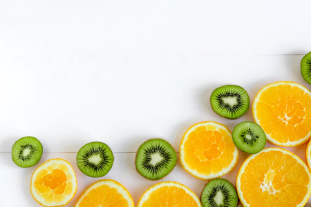 Fresh kiwi and orange sliced. Background for the profile, design, printing with fruit. The basis for the banner with orange and kiwi. Fresh and natkralnye vitamins.の写真素材