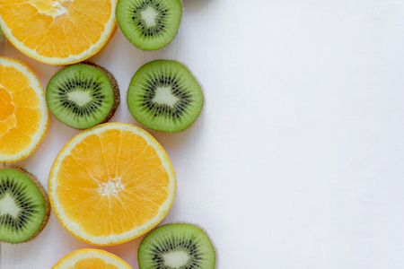 Fresh kiwi and orange sliced. Background for the profile, design, printing with fruit. The basis for the banner with orange and kiwi. Fresh and natkralnye vitamins.の写真素材