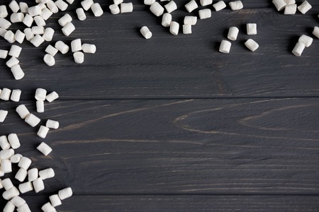 Marshmallows on a black wooden background. Background with sweets.の写真素材