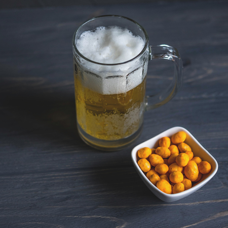 Photo of a glass of beer with nuts. Light beerの写真素材