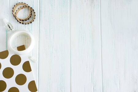 Frame for beauty banner with notepad and decorations. Women's hand bracelets on a wooden background....