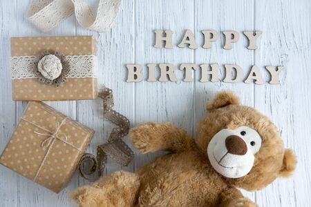 Inscription Happy Birthday. Toy bear, boxes with gifts and a congratulatory inscription happy birthday.の写真素材