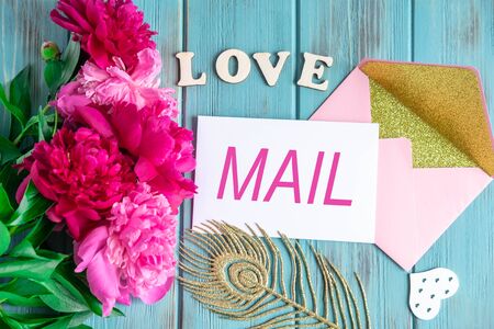 Love email background. Blue color wooden background with flowers peonies, envelopes.の写真素材