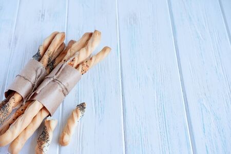 Background for a bakery, a department for the sale of bakery products. Photo of bread and bread sticks on a gray wooden background. Homebaked breadの写真素材