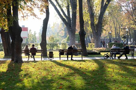 Park in the fall. People rest in the autumn park in nature. Fun and relaxation in the cityの写真素材