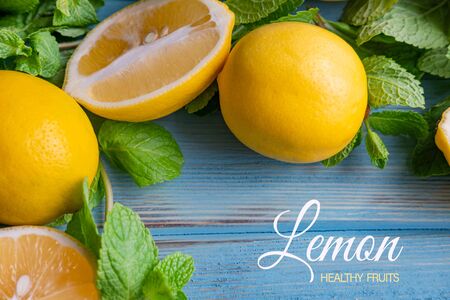 Whole and sliced lemons on a wooden blue background. Vitamin C.の写真素材