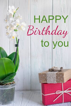 Vertical birthday card with orchid and box with a gift. Designer Birthday Greeting Card. Photo for blogの写真素材