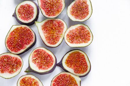 Sliced figs on a light background. Healthy fruits. Nutrition with diet, vegetarianism, healthy nutrition.の写真素材