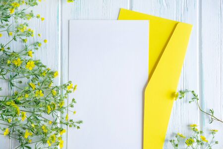 Mock up template with yellow wildflowers on a wooden background. Frame for an inscription, text with flowers.の写真素材