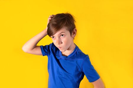 Closeup boy emotion thinks. 9 years old boy reflects on a new ideaの写真素材