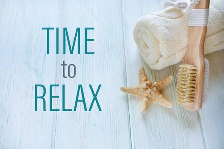 Time to relax. SPA card with massage brush, towel and starfishの写真素材