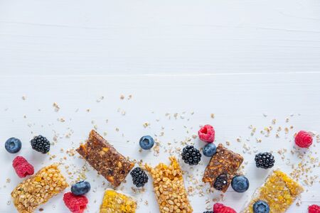 Energy bars with raspberries, blueberries, blackberries below the background. Healthy diet food. Nutrition in the morningの写真素材
