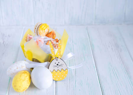 Easter cake beautifully decorated with icing, Easter eggs, rabbit. Easter composition on wooden background with place for textの写真素材