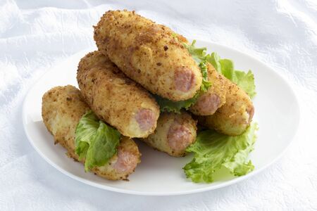 In mashed potatoes invested sausage and fried.