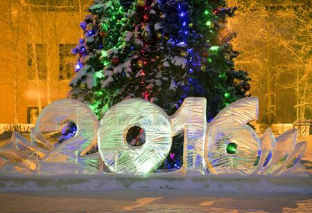 Ice 2016 figures on the Christmas tree in the night city.の写真素材