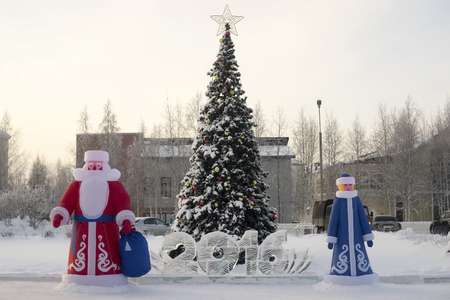 Inflatable Santa Claus near the Christmas tree on the square.の写真素材