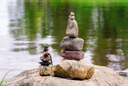 Two pyramids of stones on the lake. Ladoga skerries