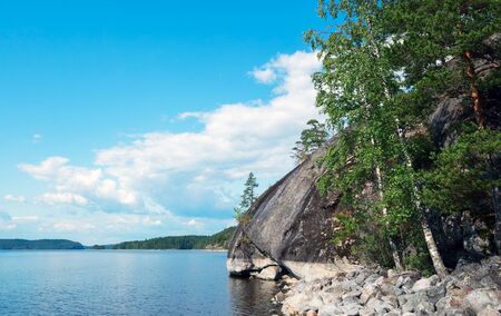 The steep coast of the island of Mussarat on lake Ladoga .の写真素材