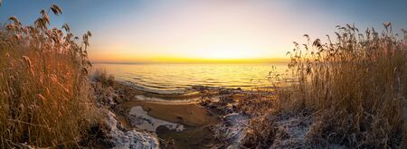 The first rays of the sun over lake Ladoga in the morning in winter. Leningrad region .Panorama.の写真素材
