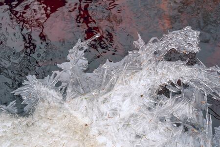 Thin ice on a stream in the forest in early spring. Vsevolozhsk. Leningrad region