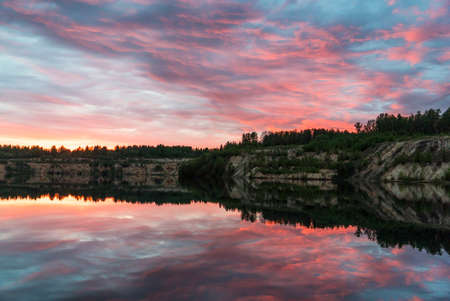 Mirror image of the sunset on the lake in spring.の写真素材