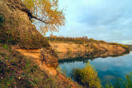 The sandy shore of a mountain lake in the fall. Leningrad region.の写真素材