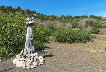 A sculpture made of stones and wood in the form of a bird in a nestの写真素材