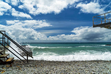 The sea is stormy. Large waves break on the breakwater .Crimeaの写真素材
