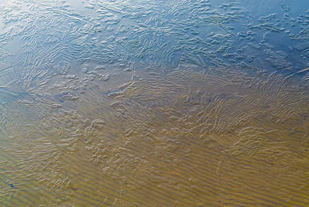 Thin ice on the water of a sand pit in late autumn. Leningrad region, Vsevolozhsk.の写真素材