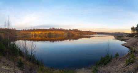 The windless surface of the lake and the reflection of clouds on calm water. Leningrad region, Vsevolozhsk.の写真素材