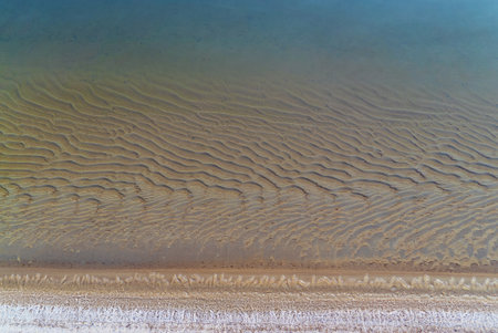 Thin ice on the water of a sand pit in late autumn. Leningrad region, Vsevolozhsk.