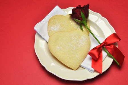 Heart shape shortbread cookies and red rose for that special someone on Valentines Day or love theme occasion の写真素材