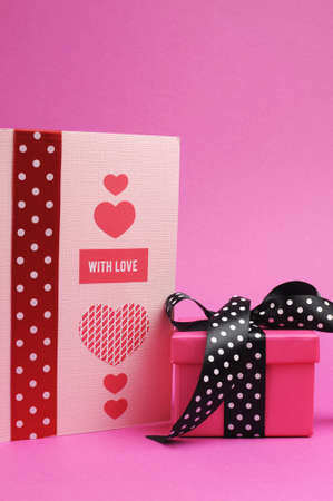 Cute and sassy pink and black polka dot gift with handmade gift card and  with love  greeting on pink background の写真素材