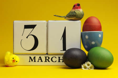 Easter Sunday, March 31, block calendar save the date, with colorful easter eggs against a bright yellow background の写真素材