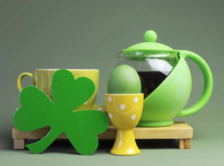 St Patrick s Day breakfast with green tea pot of coffee, egg cup, leprechaun hat and shamrock の写真素材