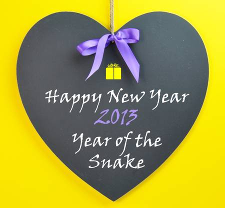 Happy New Year, 2013 the Year of the Snake in Chinese astrology, message on a blackboard with purple...