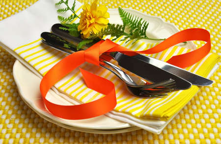 Yellow theme silver cutlery, plates and serviette napkins for a modern twist on traditional table setting elegance  For Easter or special occasion の写真素材