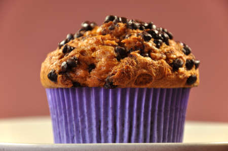 Chocolate Chip Muffin on a stone plate for a delicious treat, snack or fancy food serving at home or in a restaurant, at coffee break time の写真素材