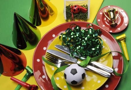 Soccer football celebration party table settings in red, green and yellow team colors の写真素材