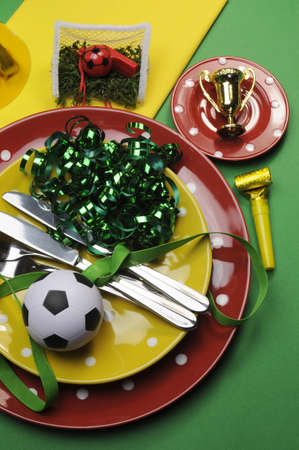 Soccer football celebration party table settings in red, green and yellow team colors の写真素材