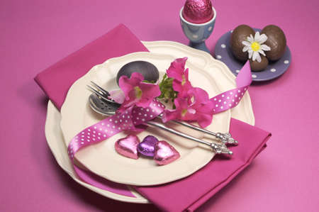 Decorative Happy Easter dinner table setting with boiled and chocolate Easter eggs の写真素材