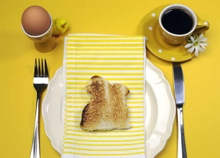 Yellow theme Happy Easter breakfast table with bunny rabbit toast and egg 