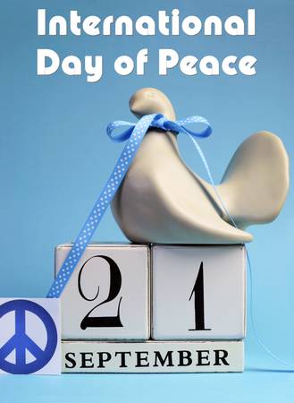Dove and Peace Sign decorations for International Day of peace, World Peace Day, with white block calendar date on pale blue background  Vertical with title message text の写真素材