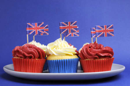English theme red, white and blue cupcakes with Great Britain Union Jack flags for national party celebrations.の写真素材